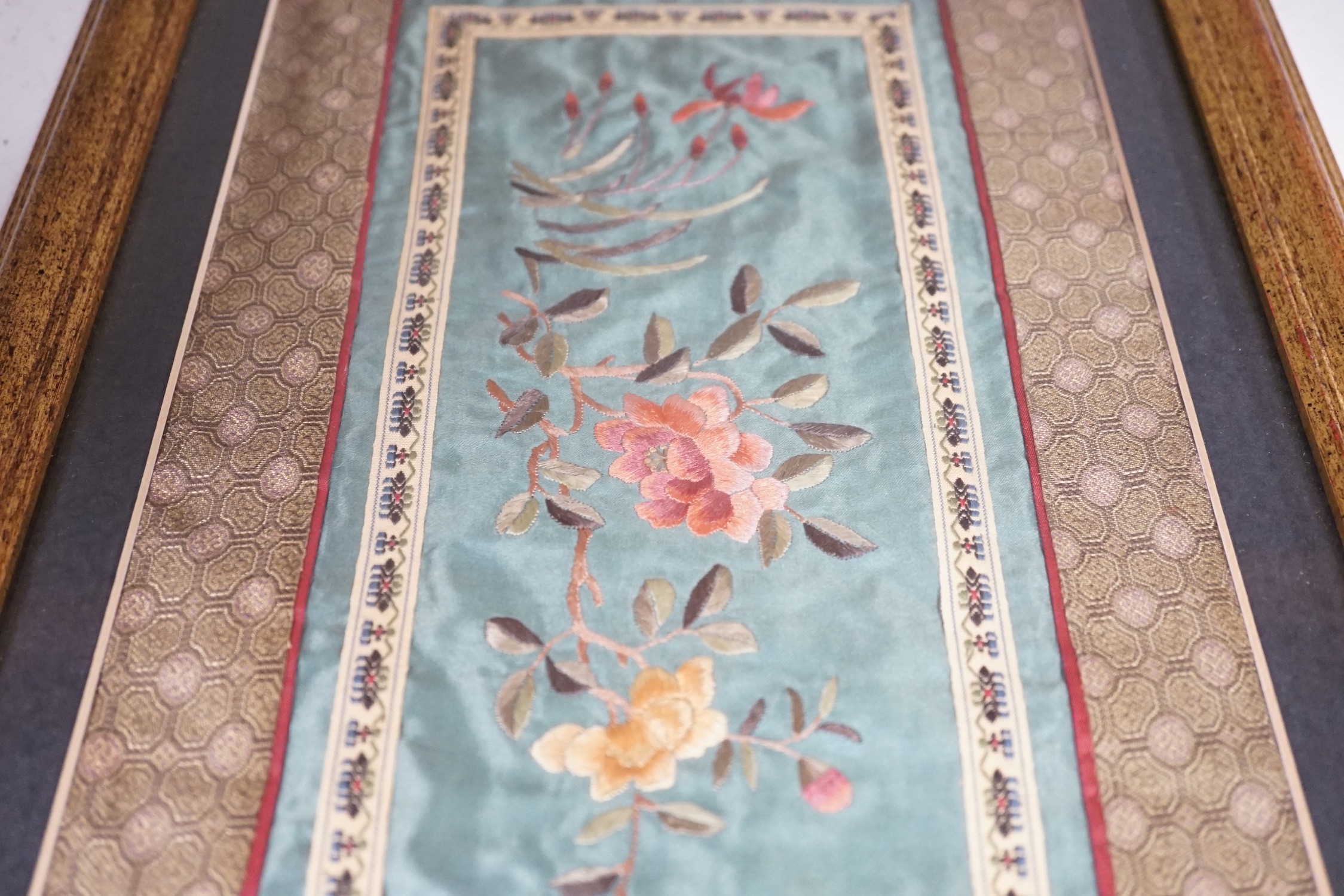 A pair of framed Chinese embroideries with bird and flower decoration, 34 x 14cm